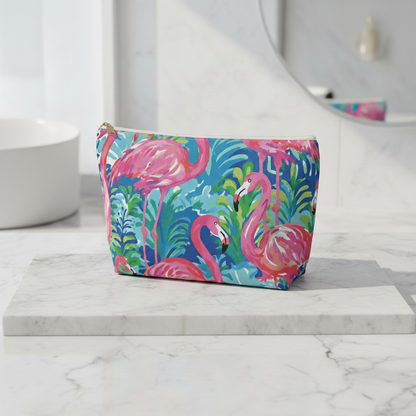 Colorful makeup bag with flamingo design on a marble surface