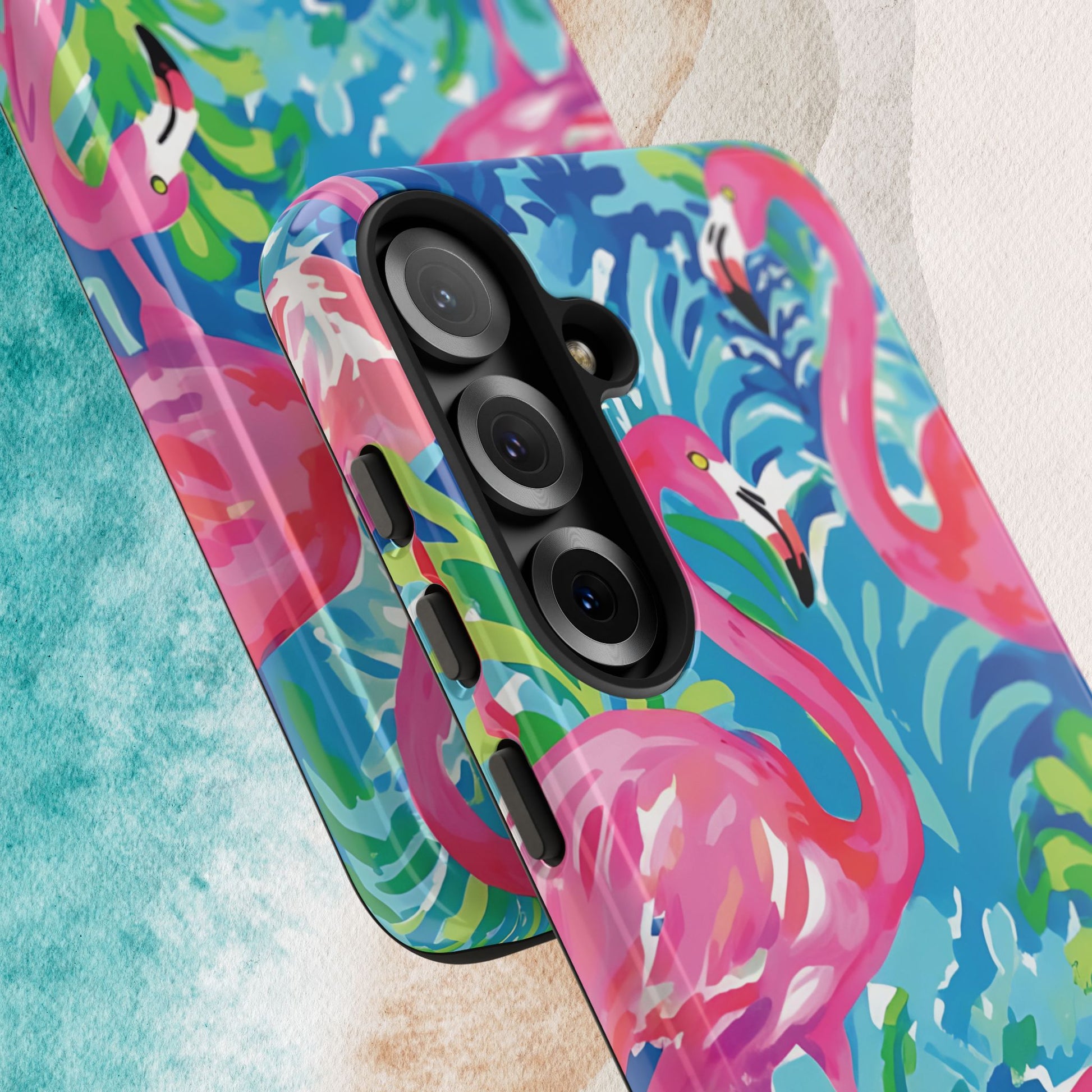 Close up views of Key Largo Tough Case for Galaxy with colorful flamingo design on a textured surface