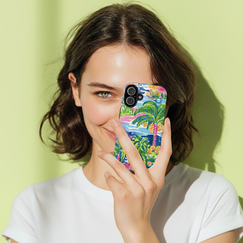 Woman holding a colorful Kiawah case for iPhone with a palm tree design against a light green background