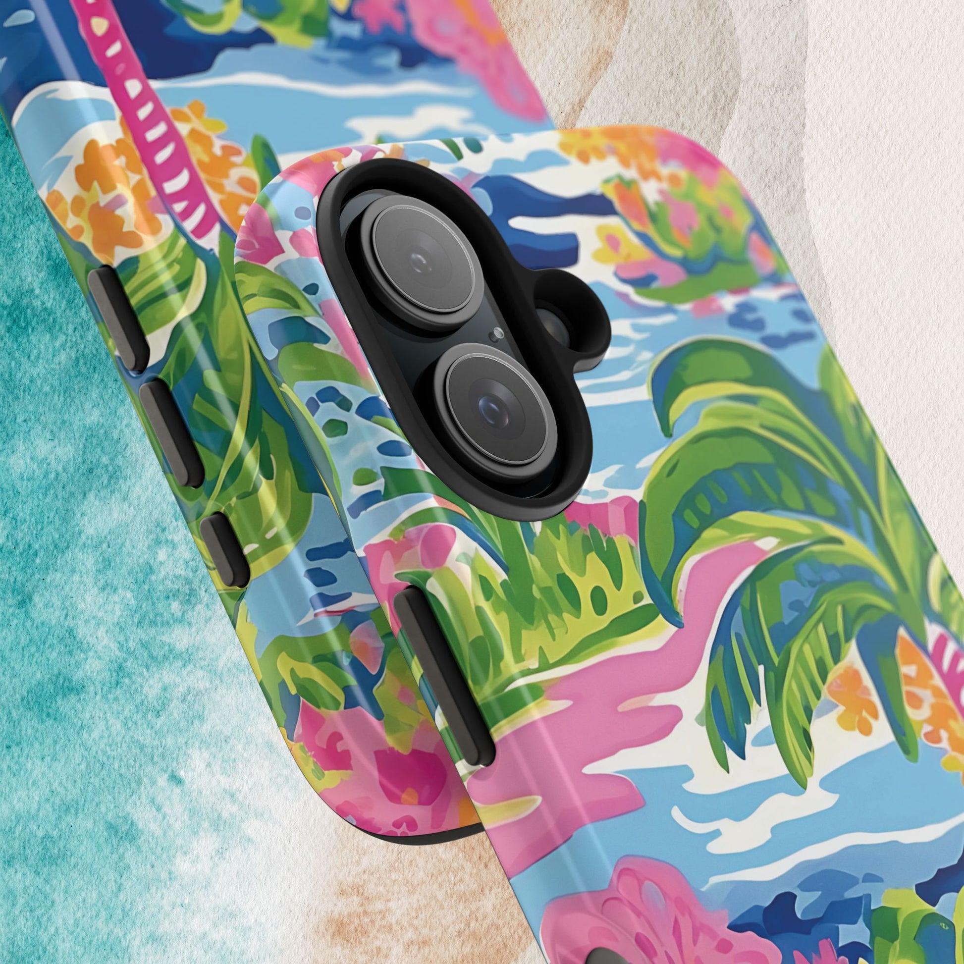 Close up views of the Kiawah Tough phone case with tropical design featuring palm trees and flowers on a colorful background