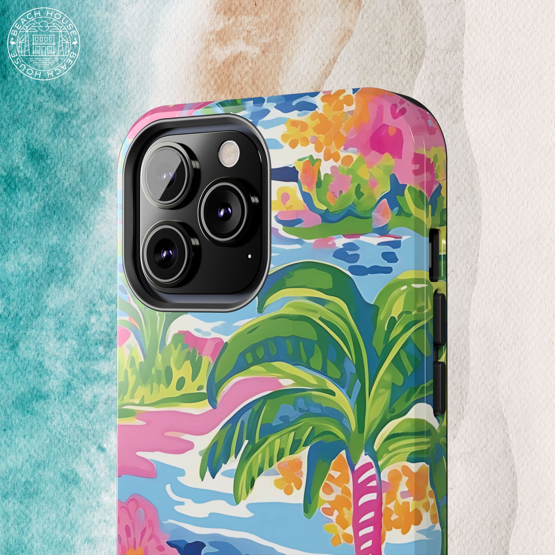 Close up view of Kiawah Tough Case for iPhone with tropical design featuring palm trees and flowers