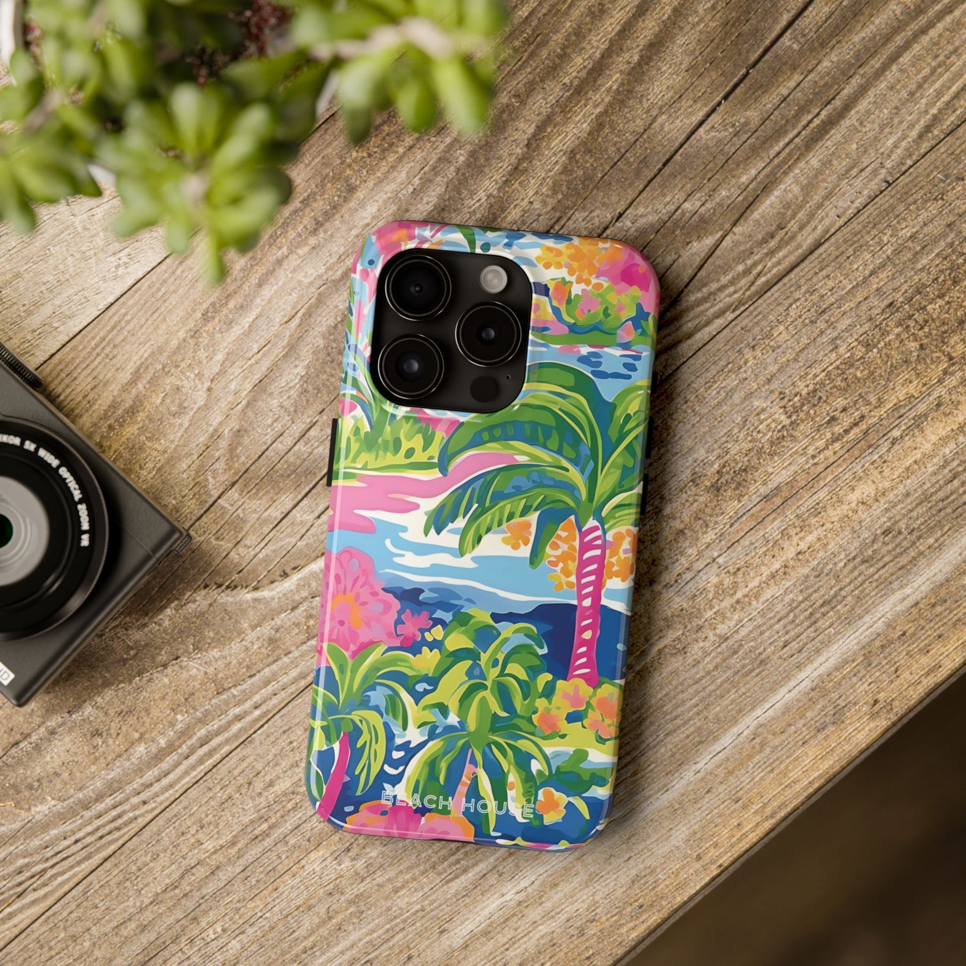Kiawah Tough Case for iPhone with palm tree design on a wooden surface