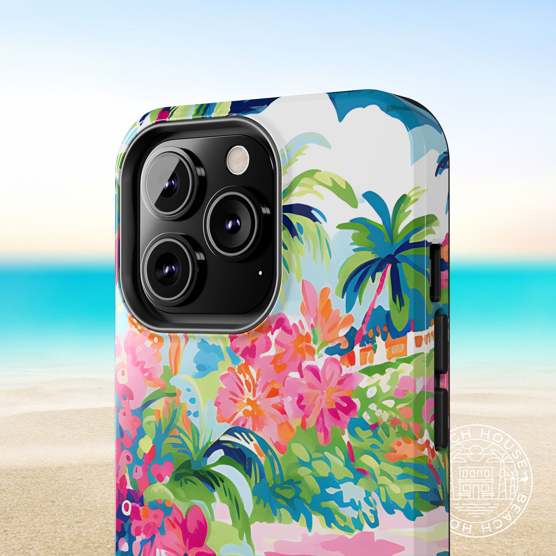 Close up view of Laguna Tough Case for iPhone with floral and palm tree design on a beach background