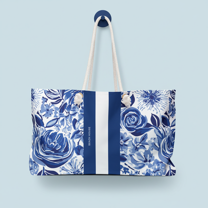Lexington Weekender Tote Bag with blue floral pattern and white stripe on a light blue background