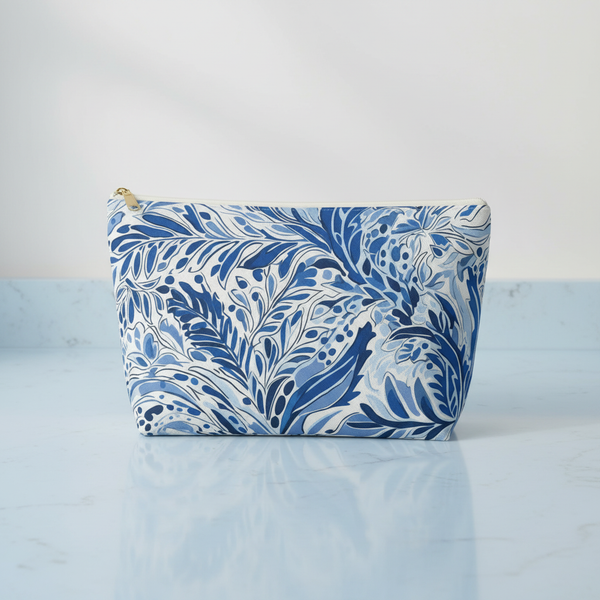 Blue and white floral patterned pouch on a light blue background