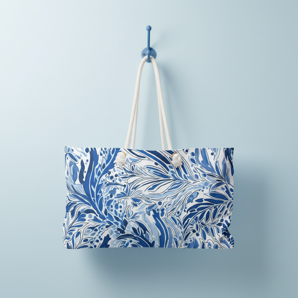 Blue and white patterned Nags Head Weekender tote bag hanging on a blue hook against a light blue background