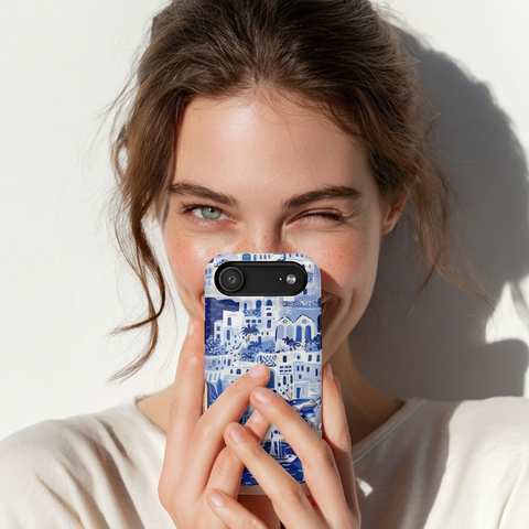 Woman holding a Santorini Case for iPhone with a blue and white patterned case against a white background