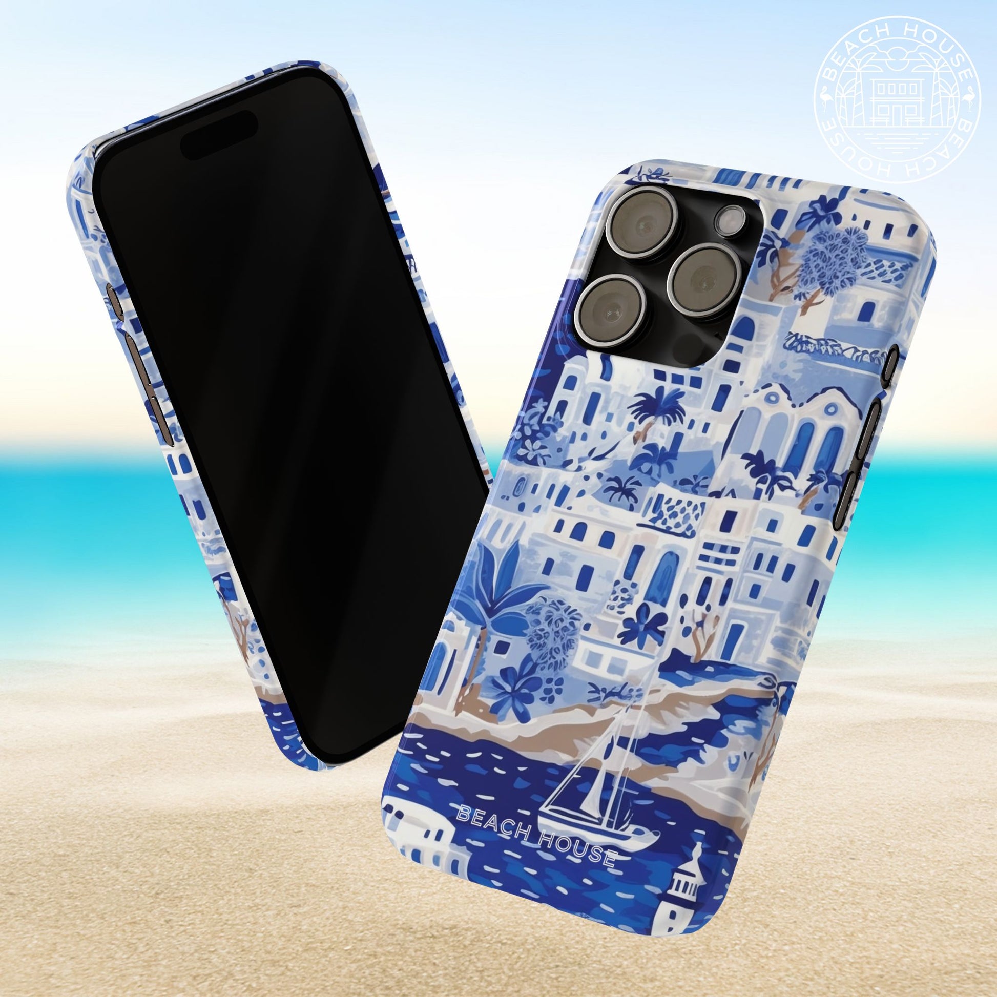 Front and back view of the Santorini Slim Case for iPhone with beach house design on a sandy background