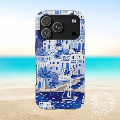 Santorini Tough Case for iPhone 17 Pro with beach house design on a blurred beach background