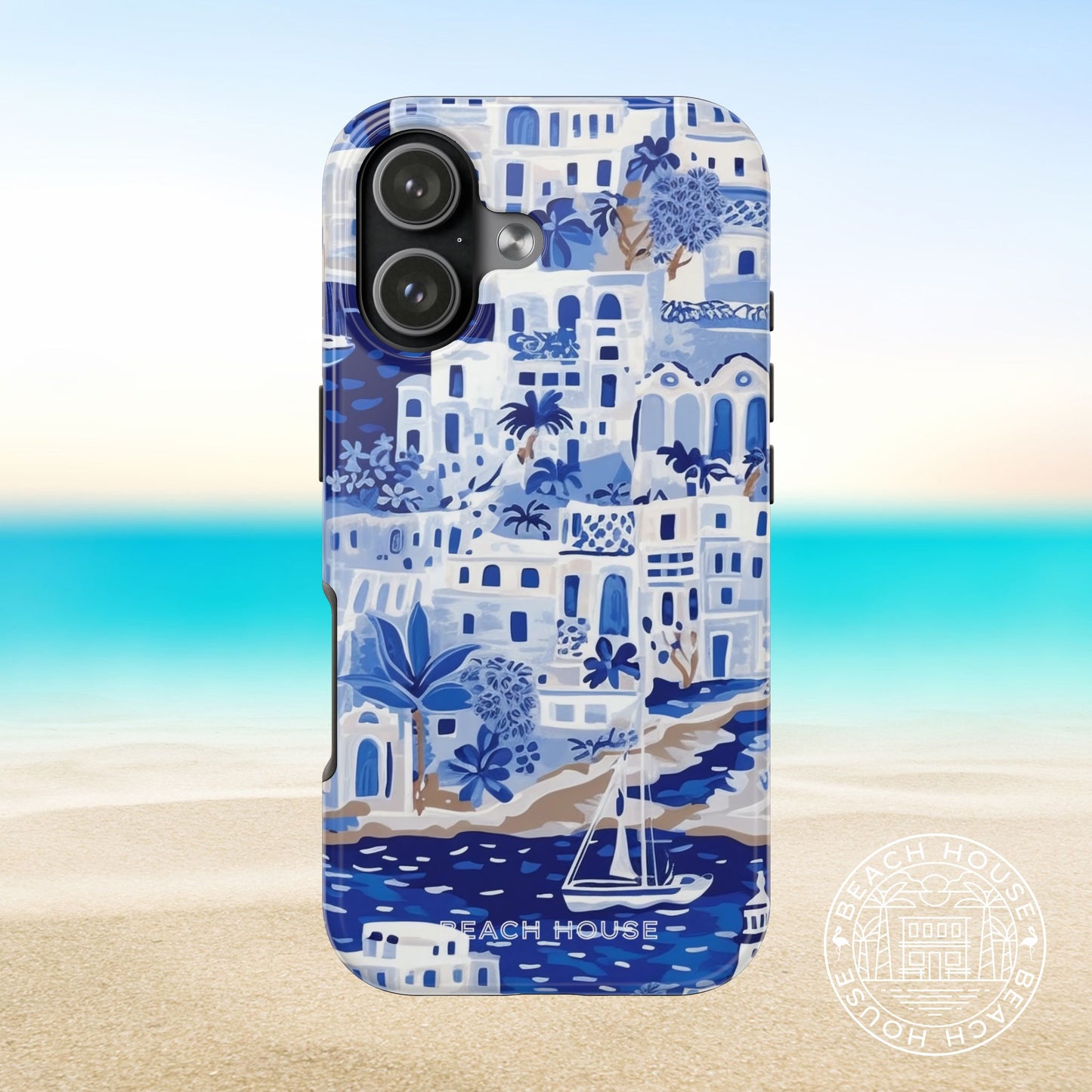 Santorini Tough Case for iPhone 17 with coastal design featuring buildings, trees, and a sailboat on a beach background.