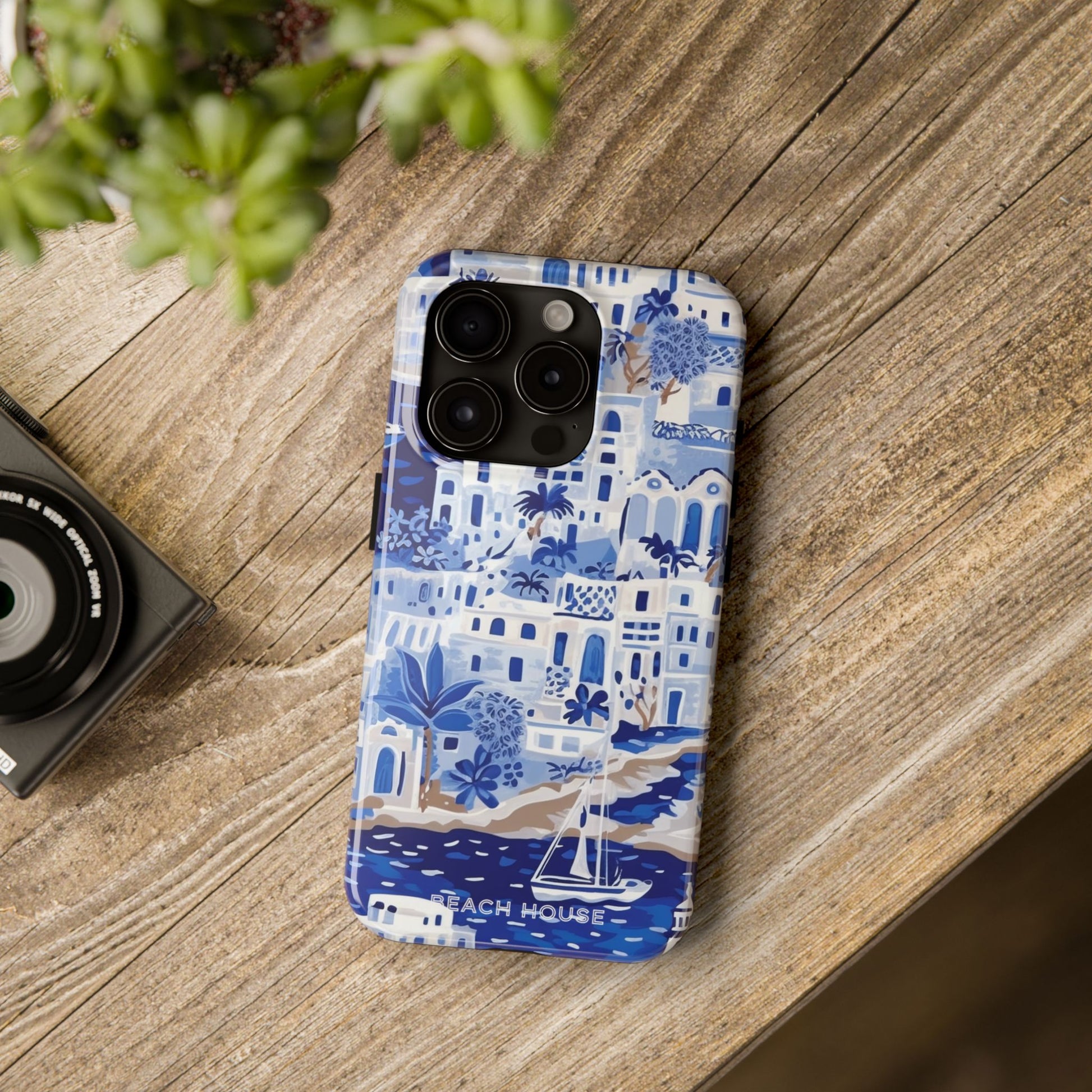 Santorini Tough Case for iPhone with blue and white coastal pattern on a wooden surface
