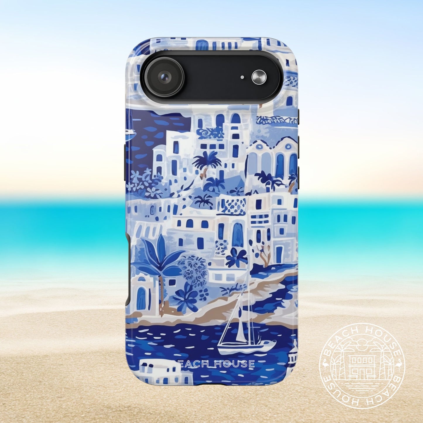 Santorini Tough Case for iPhone 17 Air with coastal design featuring buildings and a sailboat on a beach background