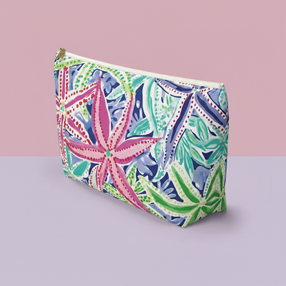 Colorful patterned pouch on a pink and gray background