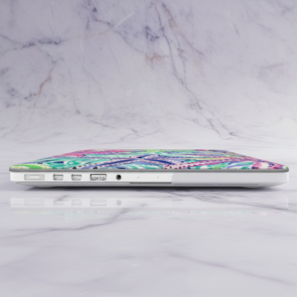 Laptop with a colorful starfish Siesta Key MacBook Case on a marble surface