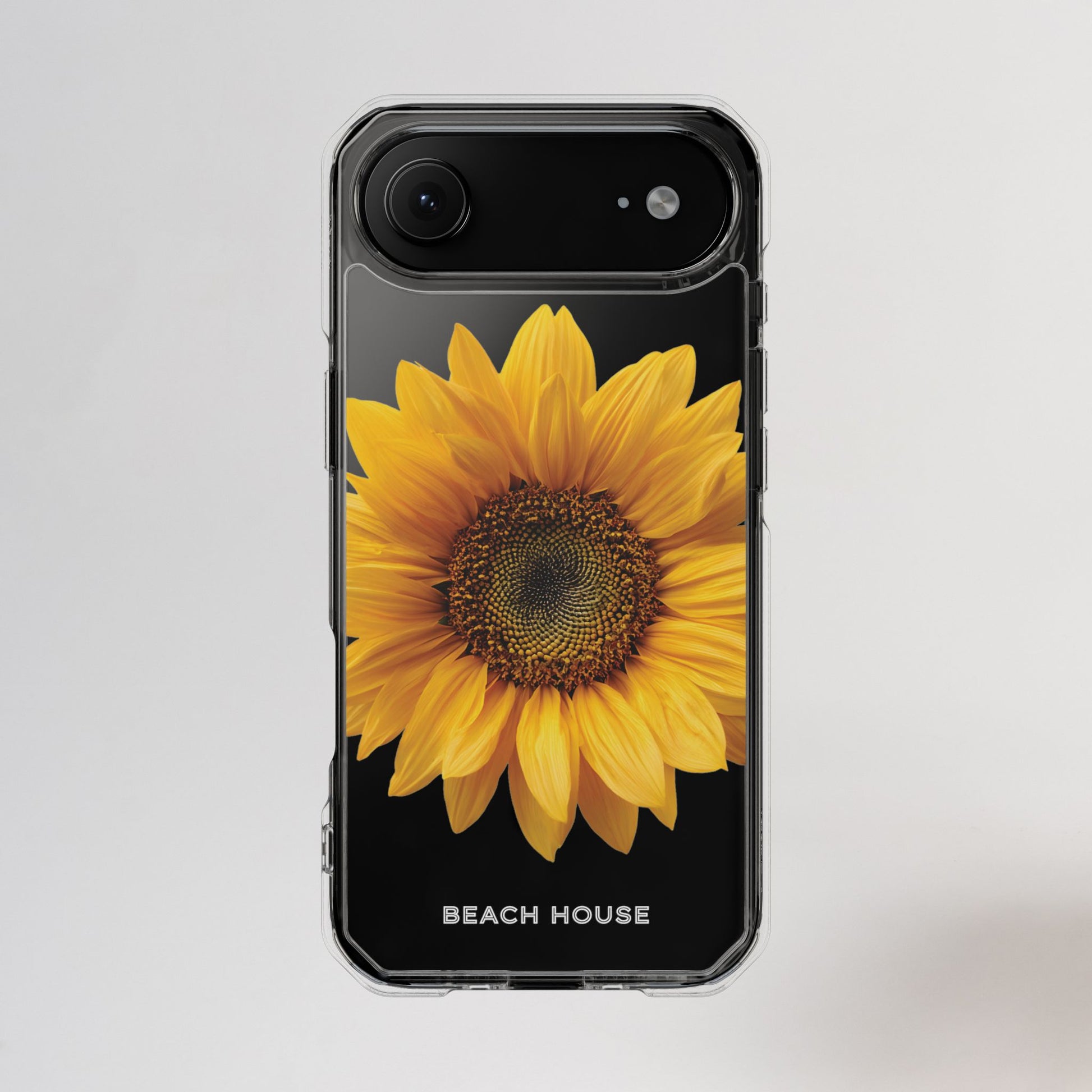 Phone case with a sunflower design and 'Beach House' text on a light gray background