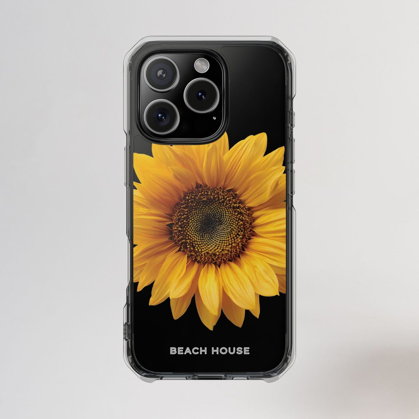 Phone case with a sunflower design and 'Beach House' text on a light gray background