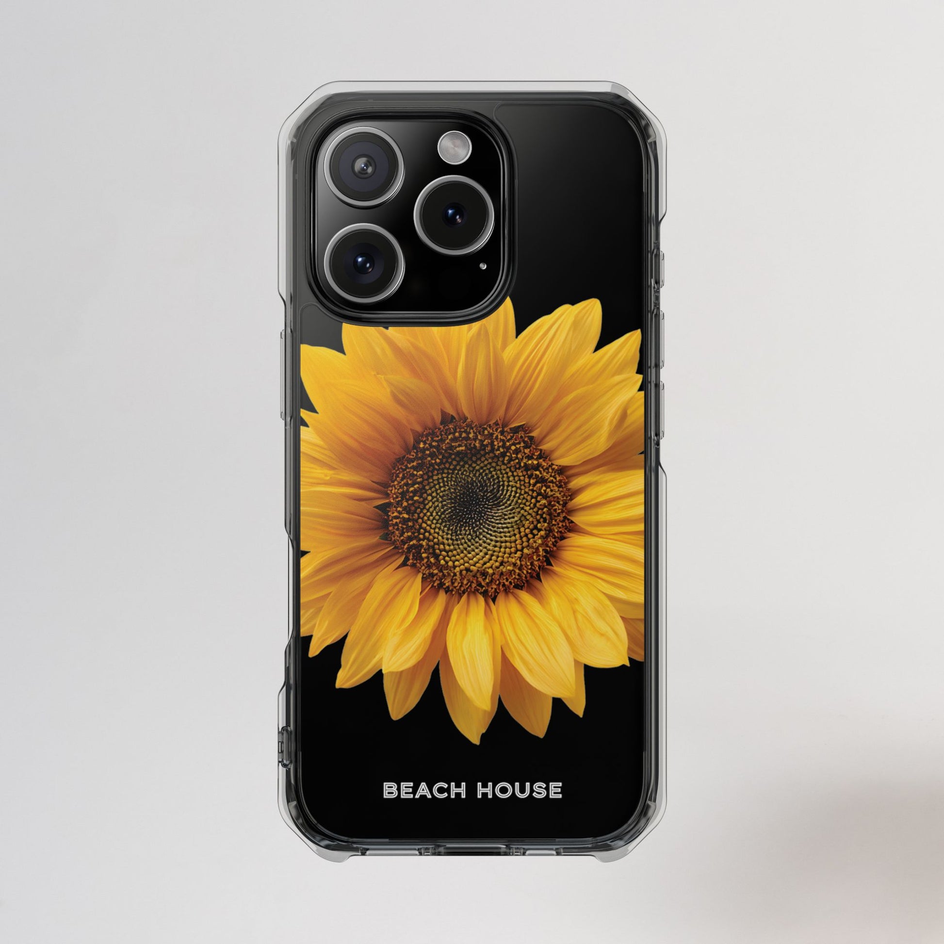 Phone case with a sunflower design and 'Beach House' text on a light gray background