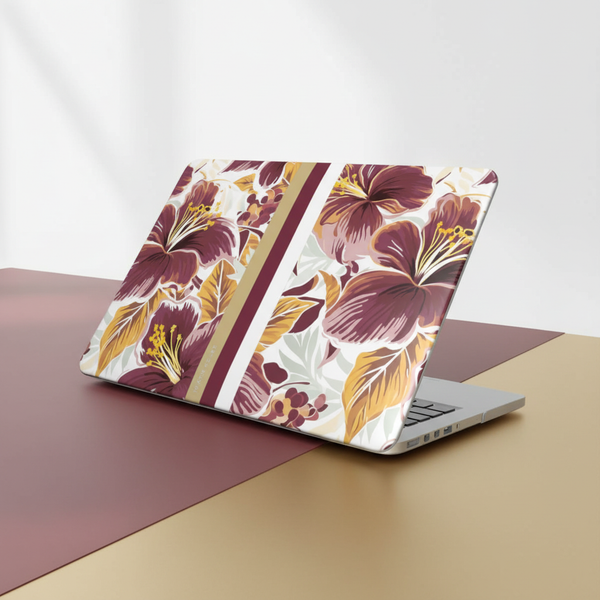Laptop with a floral Tallahassee MacBook Case on a two-tone surface