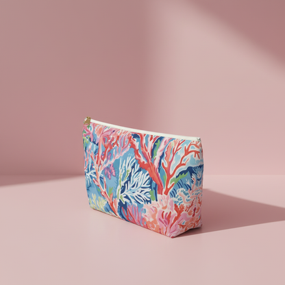 Colorful coral-patterned pouch on a pink background