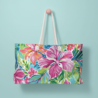 Floral Waikiki Weekender Tote Bag with rope handles on a light blue background