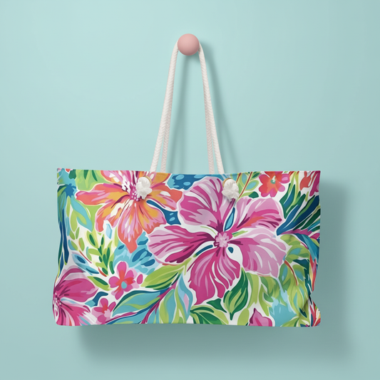 Floral Waikiki Weekender Tote Bag with rope handles on a light blue background