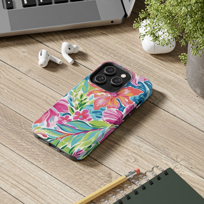 Colorful Waikiki phone case on a wooden desk with a laptop, earbuds, and notebook.