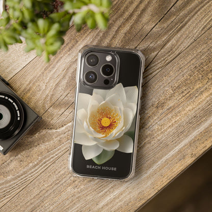 Phone case with a flower design on a wooden surface next to a camera